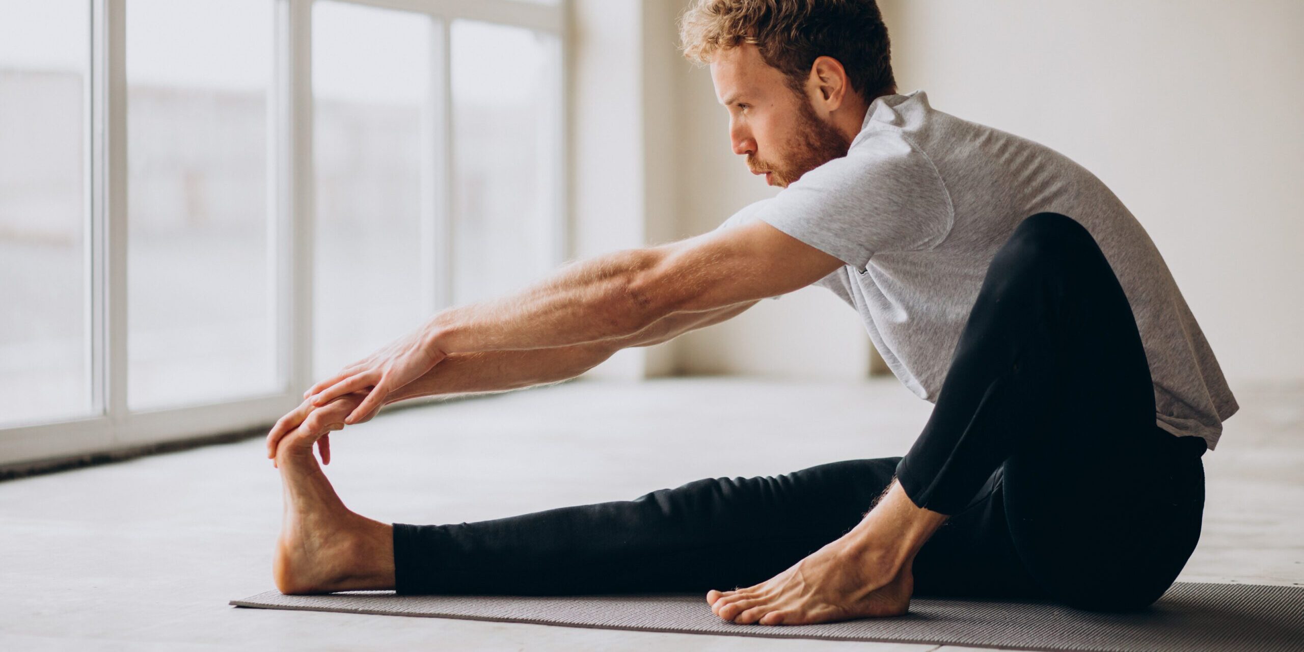 Man practicing yoga on the mat at home